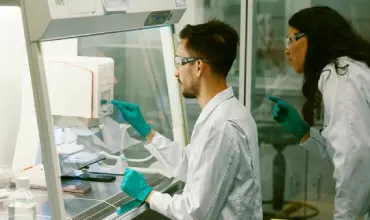 Scientists working in a laboratory with protective gear