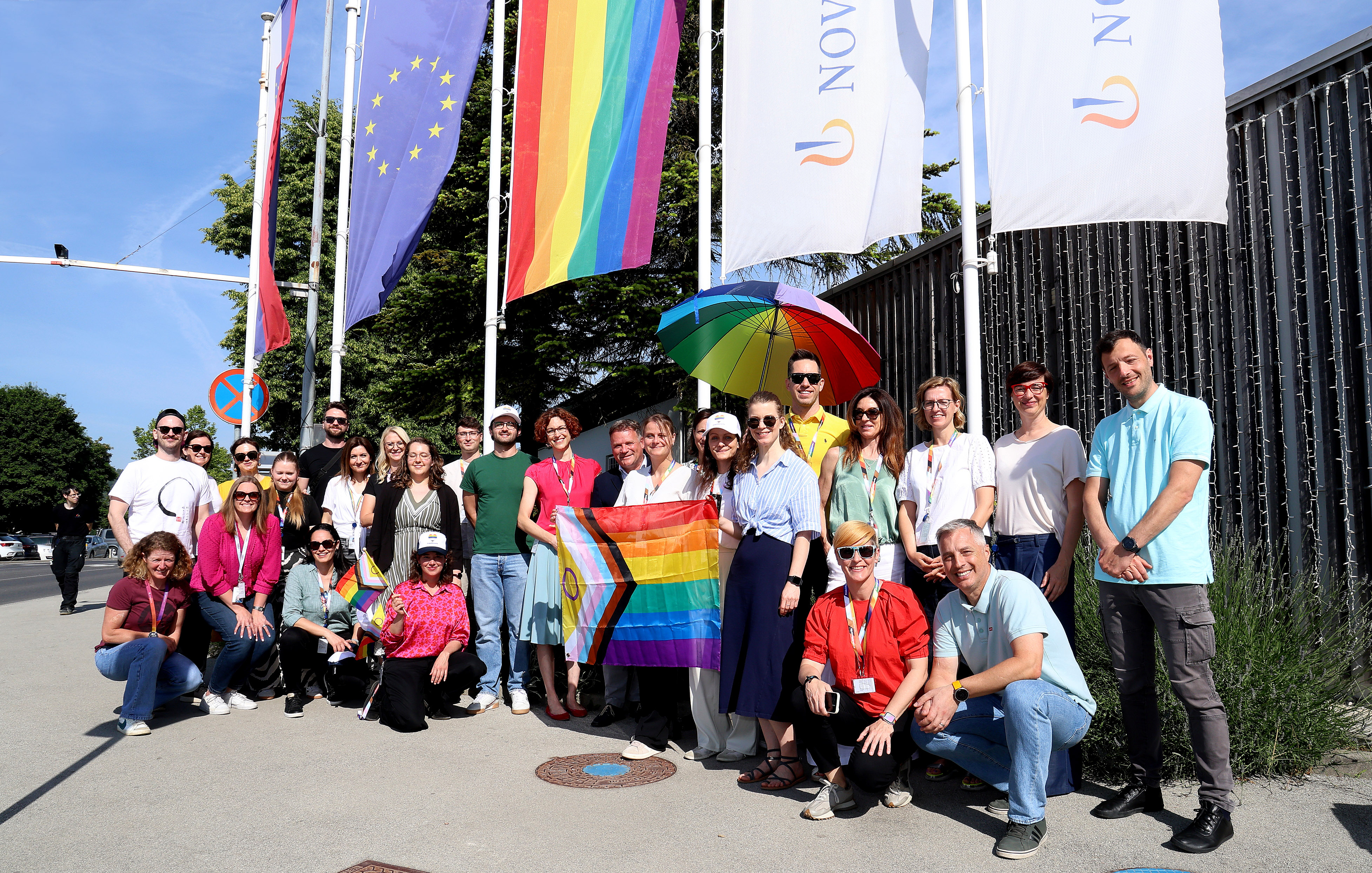 Raising the rainbow flag in front of the Novartis location in Mengš