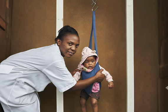 A health worker playing with a toddler