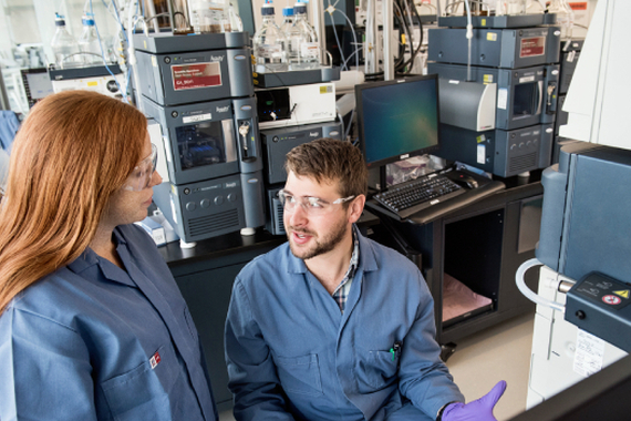 Two scientists discussing results in laboratory