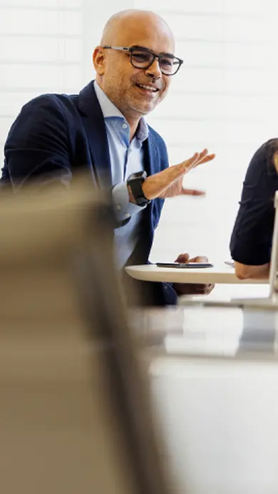 Three professionals discussing business during a meeting in an office