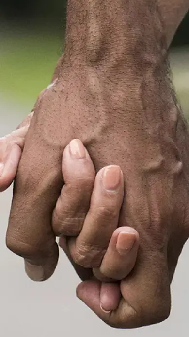 Two people holding hands