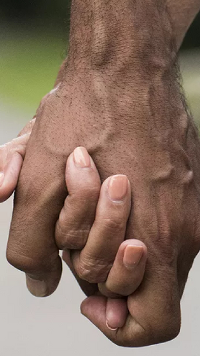 Two people holding hands