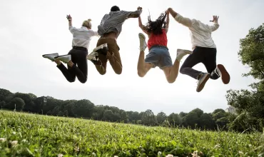 Group of young adults jumping