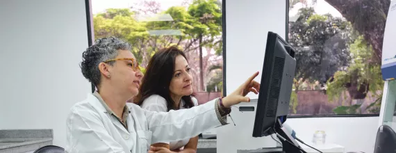 Two healthcare professionals working, loking at a screen