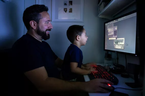 Father and son playing on computer