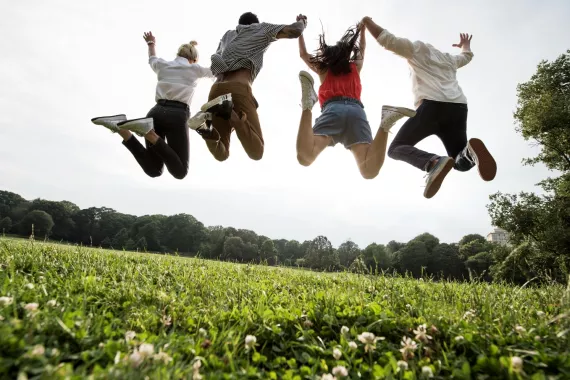 Group of young adults jumping