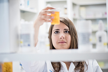 A pharmacist reviews medication for a patient