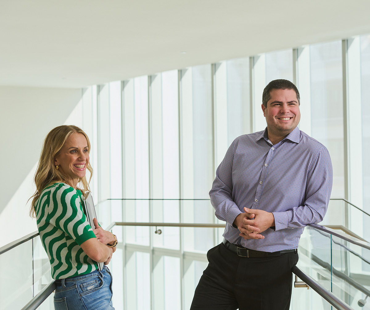 Two colleagues having a discussion in a modern, light-filled office space