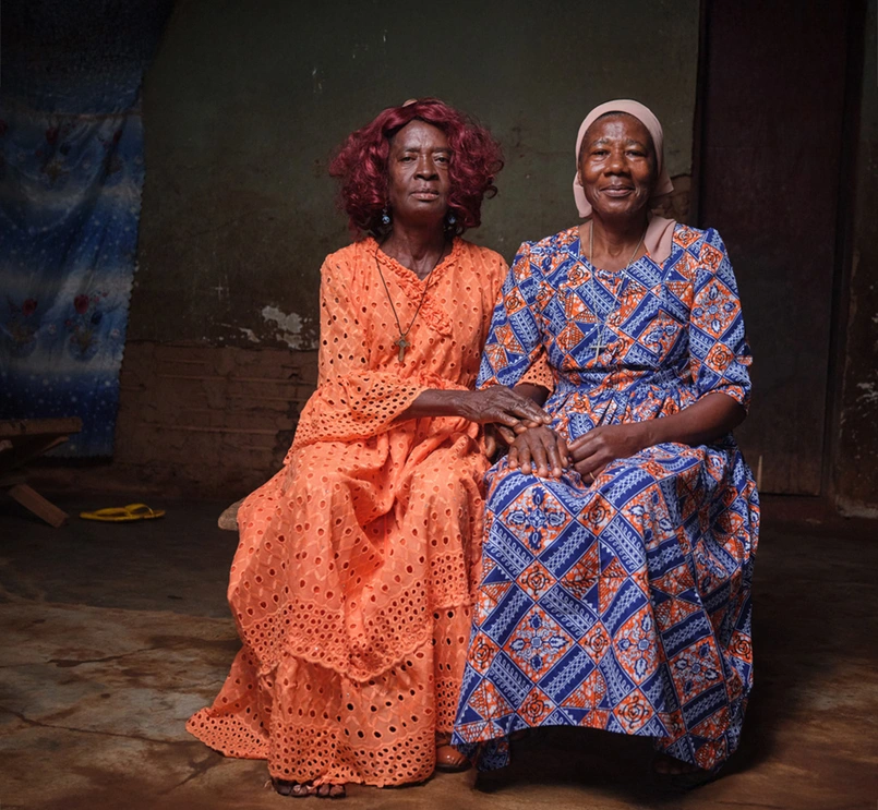 Sitting portrait of two women in colorful traditional dresses in Cameroon