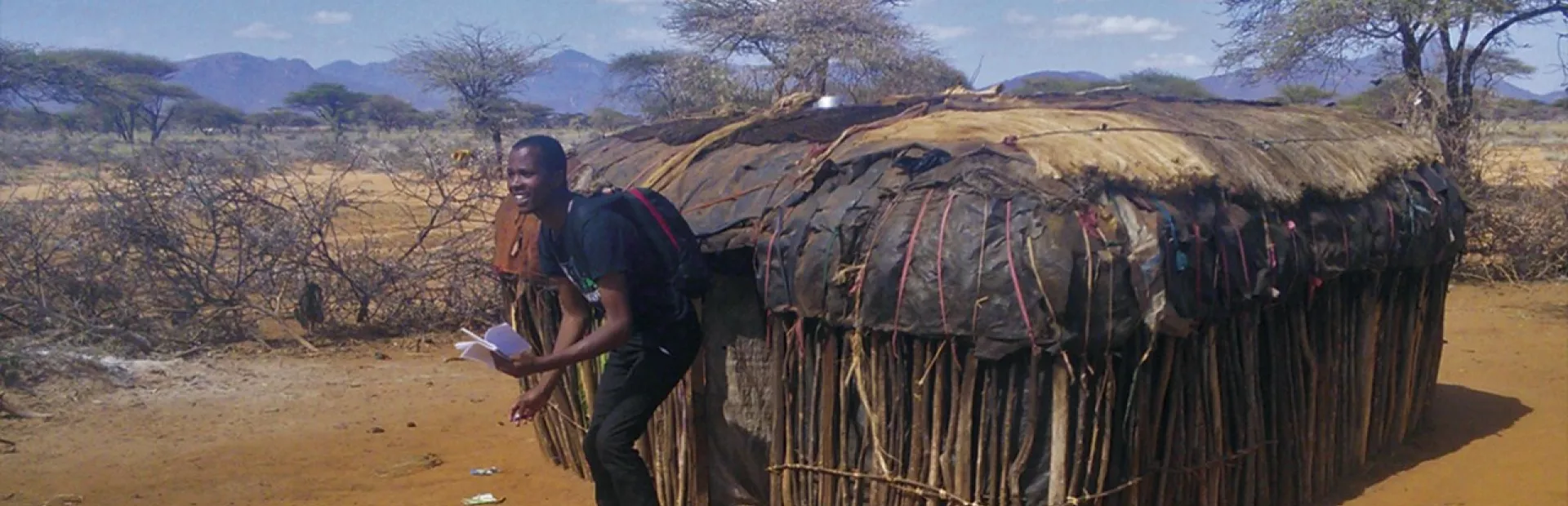 Investigator leaving a hut in Kenya