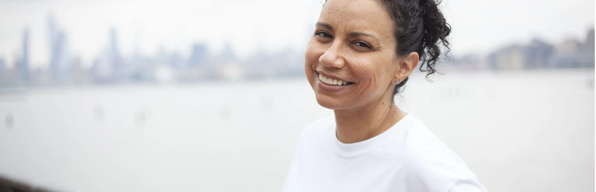 A kidney patient is smiling at the camera.