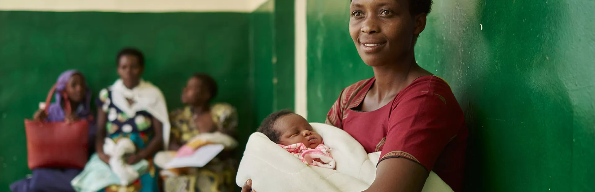 mother waiting with infant in clinic africa