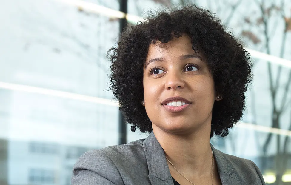 A black female Novartis associate looking into the distance