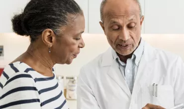 A doctor discusses different clinical trial options with a patient.
