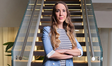 A female Director standing in-front of stairs at the Novartis office in Basel
