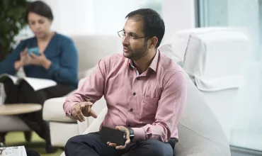 A Novartis associate talking with gestures