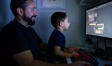 father and son infront of a computer