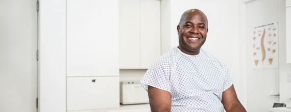 A male patient sitting in a doctor’s office
