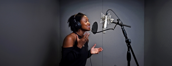 Shanelle Gabriel rehearses a poem in a studio.