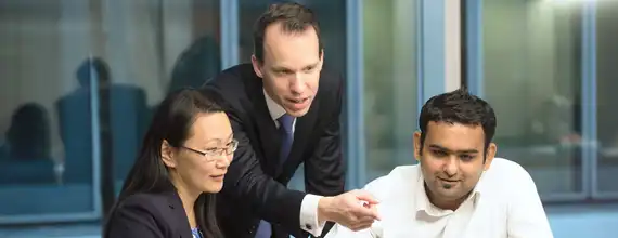 A group of three business professionals in meeting