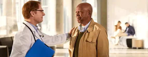 Doctor speaking with patient in hospital lobby