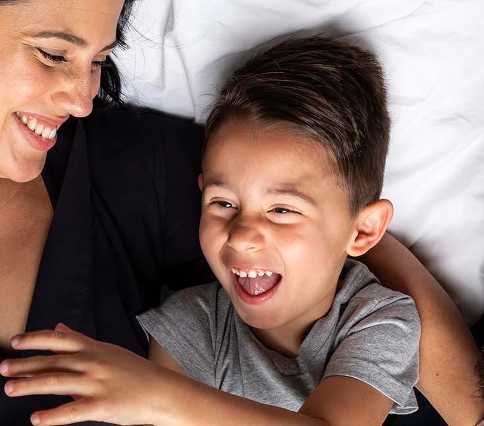 Parents snuggling with their son