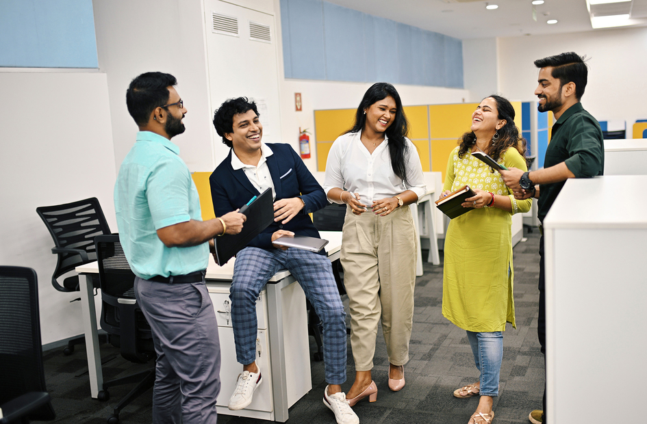 Group of five business people in India discussion and laughing