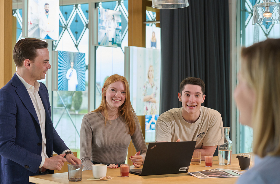 Early careers professionals smile at camera