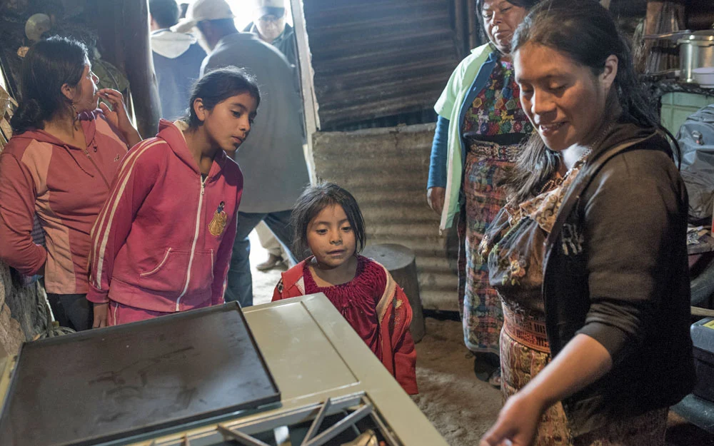 People inspect a gas stove