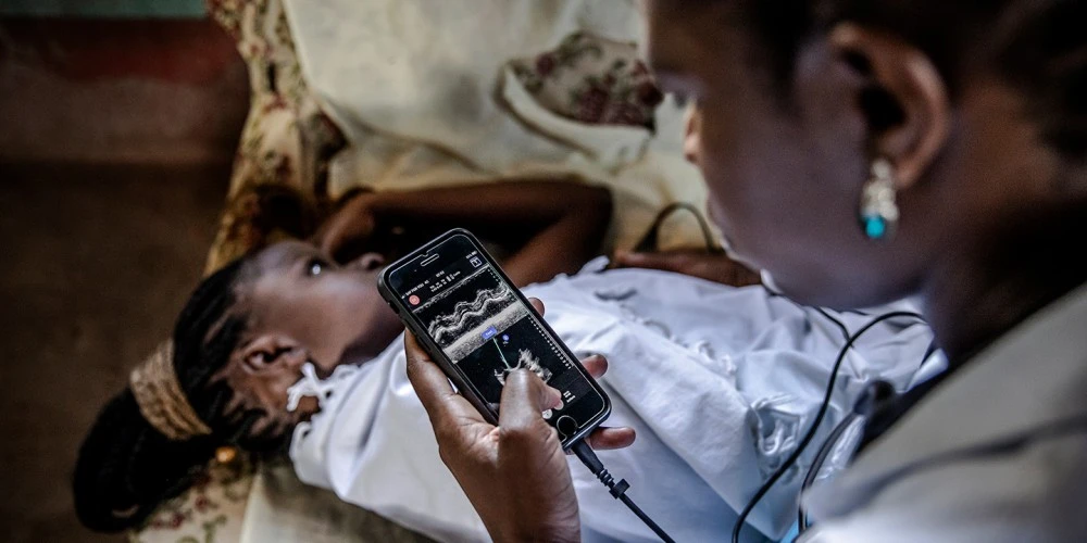 Dr. Juliet Akoth examines a patient during a home visit in Kitui, Kenya