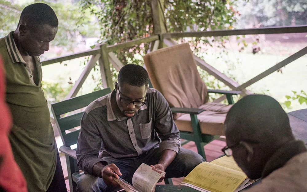 Edmund Ekuadzi discussing the search for medicinal plants with his colleagues.