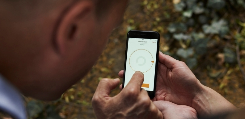 Individual interacts with digital technology via mobile phone