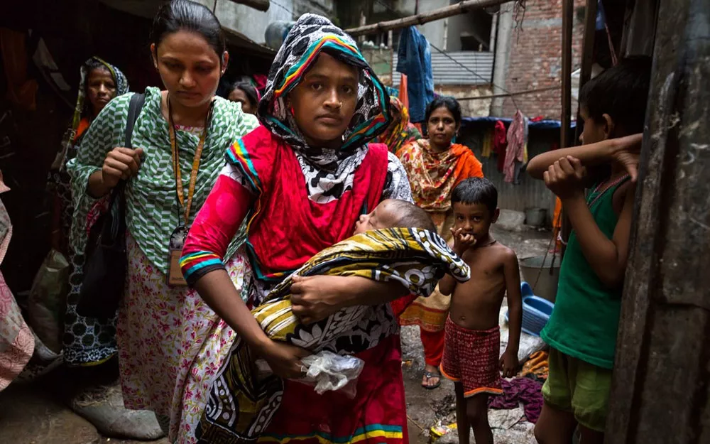 Fatima takes her 6-month-old son Foysal, who has pneumonia, for treatment in Dhaka, the capital of Bangladesh.