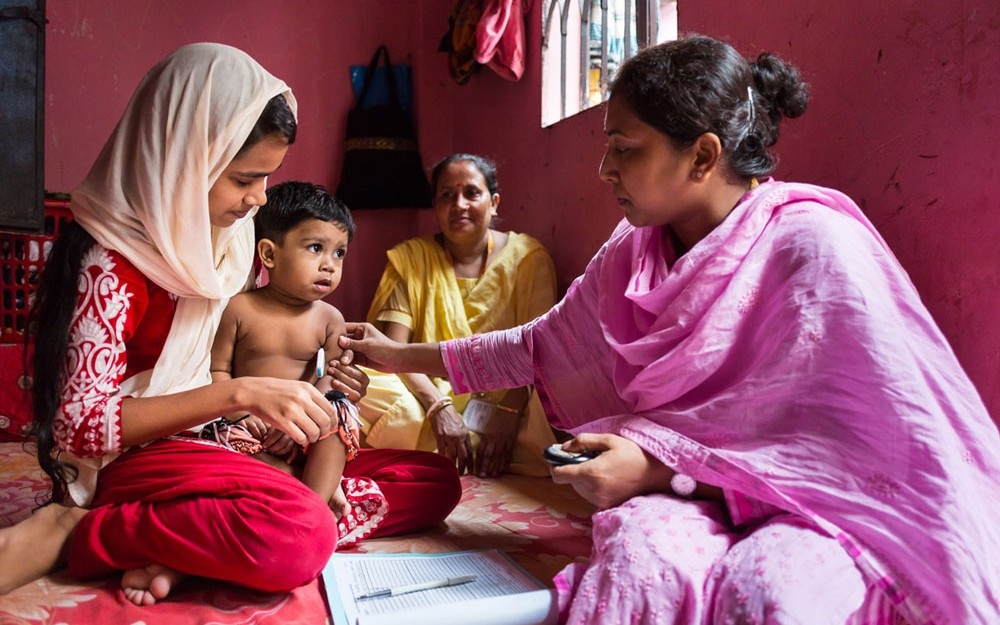 A field research assistant carries out routine checks to screen for pneumonia, the leading cause of death among young children worldwide.