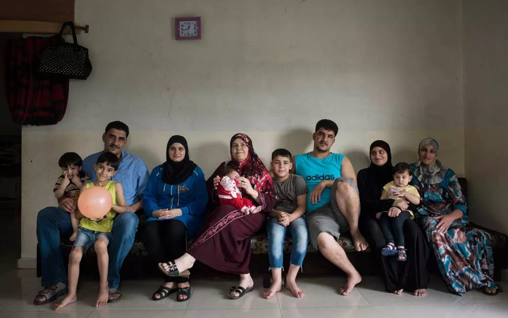 ICRC patient Elham (center) with some of her children and their families after fleeing from Syria