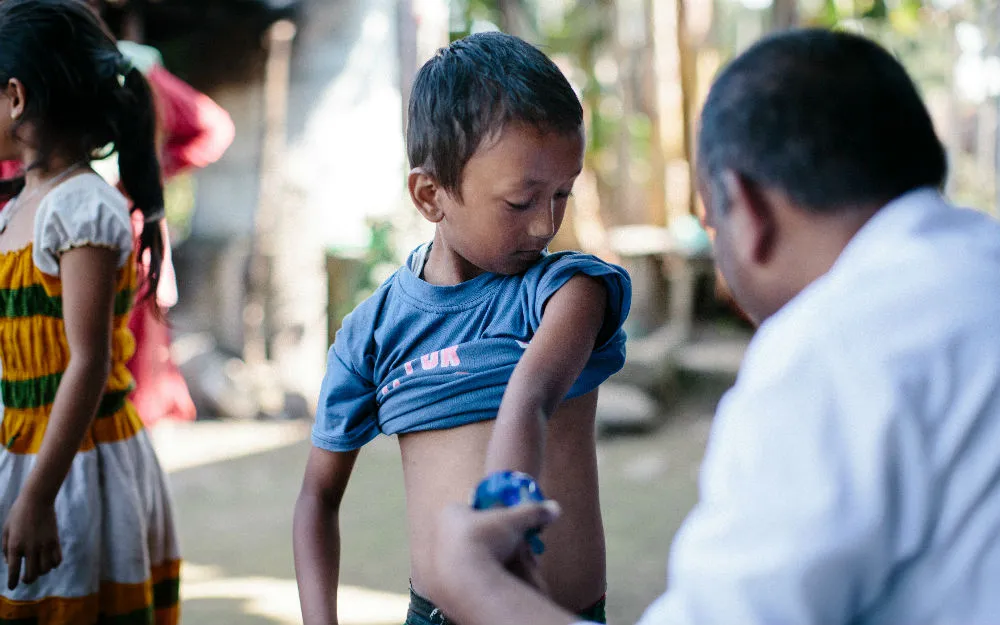 Boy being inspected for leprosy