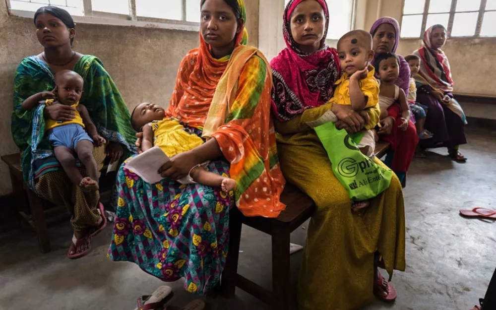Mothers wait in a clinic in Dhaka, Bangladesh for treatment for their children, who are suffering from pneumonia.  