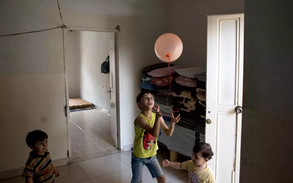 Mustafa plays in his temporary home in Bireh, Lebanon