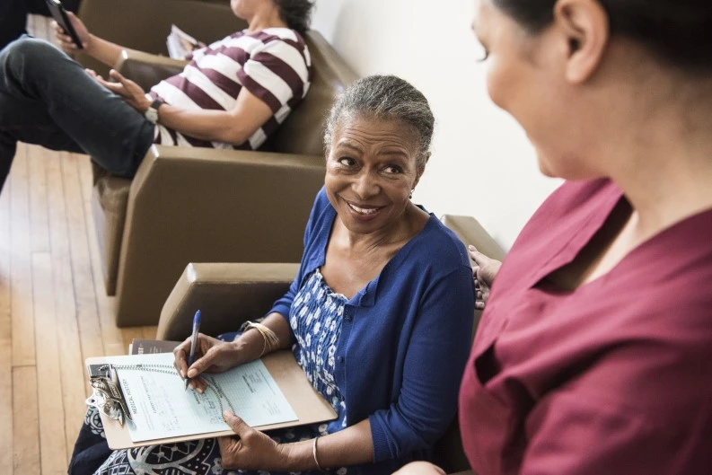 Patient smiles at nurse in waiting room