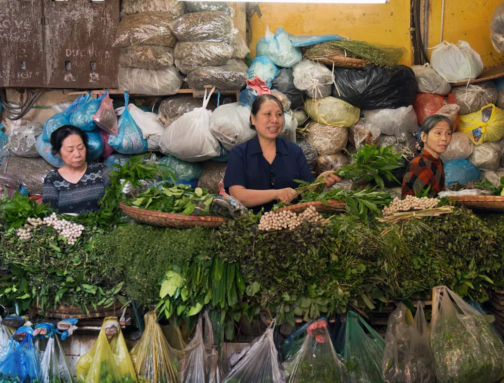 Women selling vegetables at a market in Ho Chi Minh City