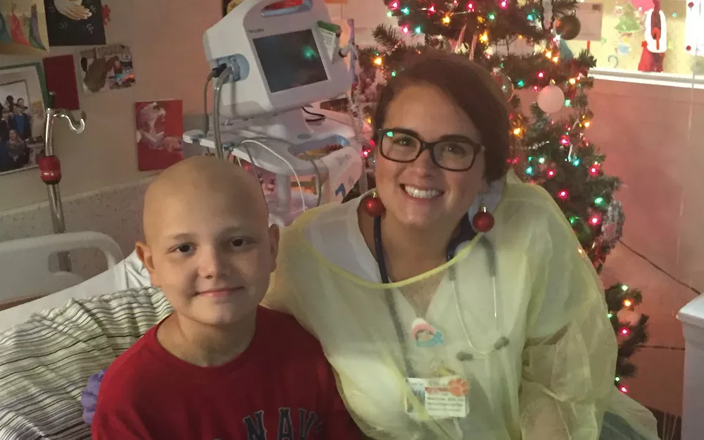 A childhood cancer patient with a nurse in the hospital during Christmas