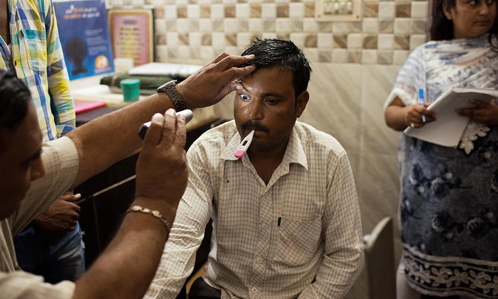 A patient receives a checkup at a health camp in the northern Indian village of Triveni Vihar.