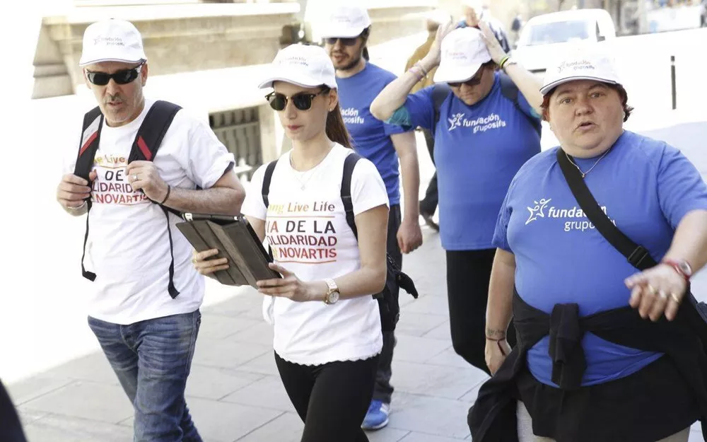 A group of Novartis employees guiding people with disabilities at a rally in Spain