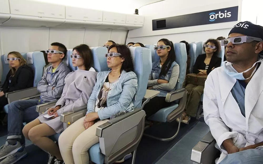 Trainees wear 3D glasses to help them visualize a surgery in progress aboard the flying hospital