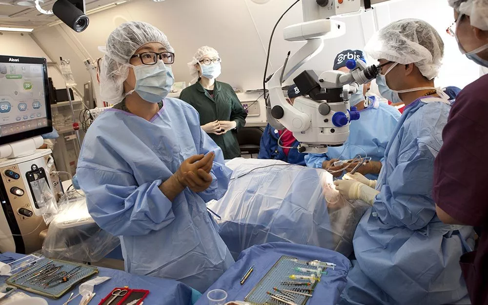 Trainees operate on a patient during an eye surgery