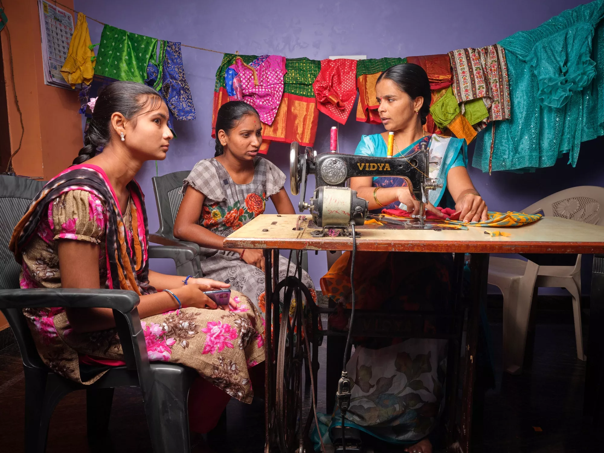 K. Balamani (right) training young women in her sewing workshop.