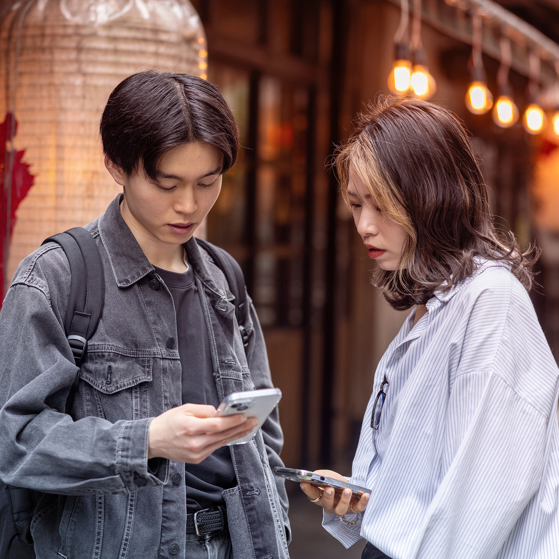 Couple talking in a traditional japanese Izakaya street