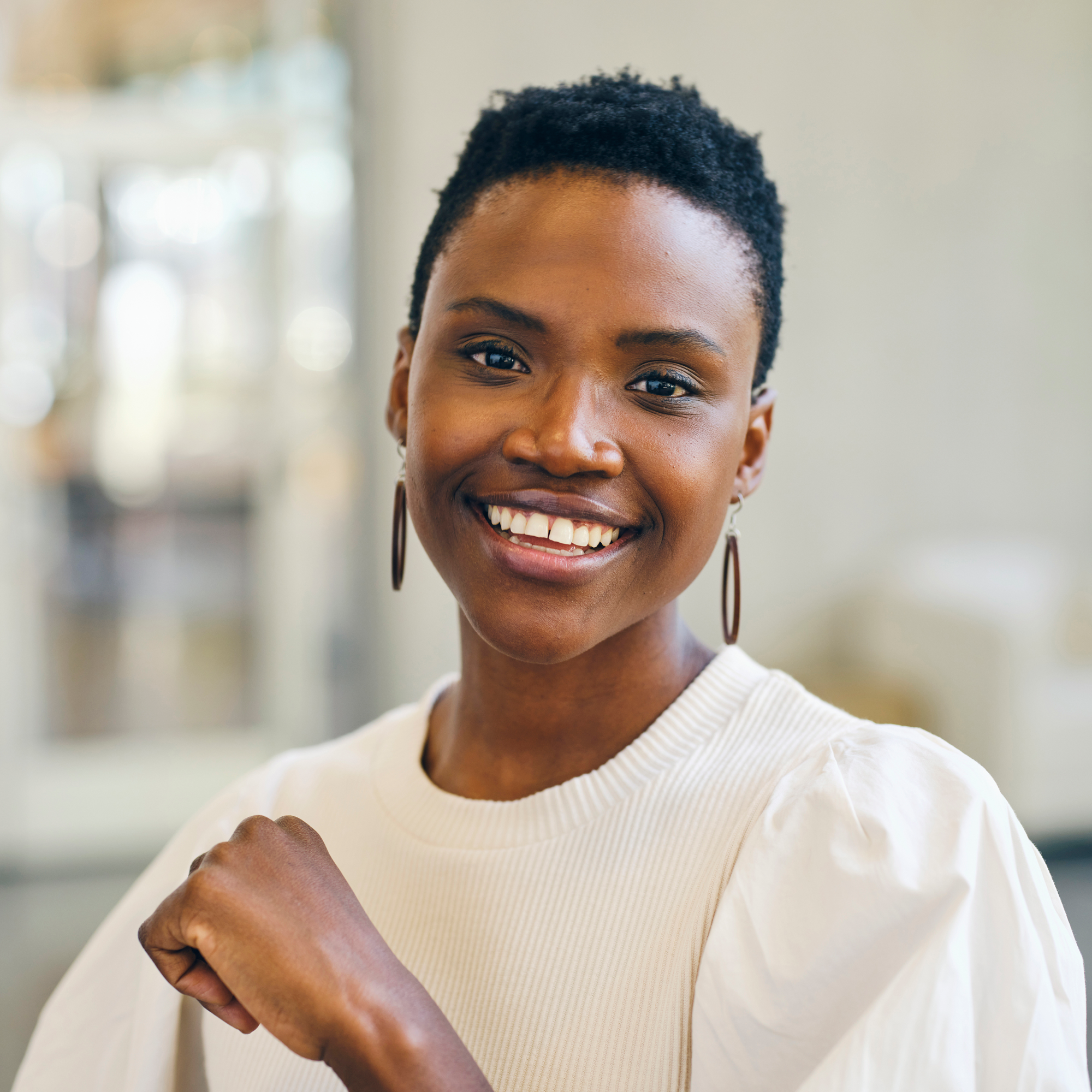 Person in a white top sitting indoors in an office
