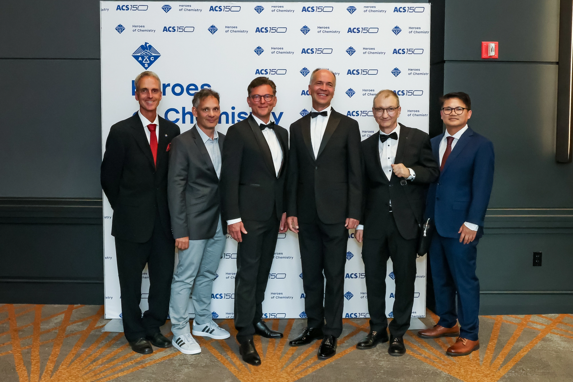 Novartis chemists received the Heroes of Chemistry award from the American Chemical Society at a recent ceremony. Their work led to a new therapeutic approach for people living with chronic myeloid leukemia (CML). Six of the awardees are pictured here, posing for photos at the event: Robert Grotzfeld, Xavier Pelle, Andreas Marzinzik, Wolfgang Jahnke, Joseph Schoepfer, Barun Okram.